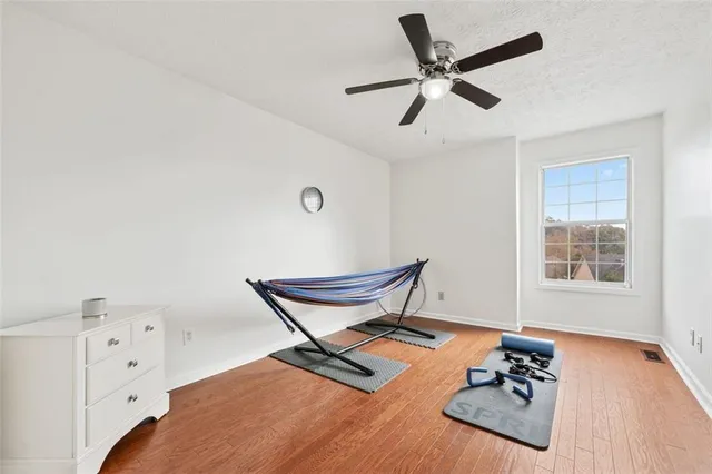 a view of workspace with wooden floor and windows