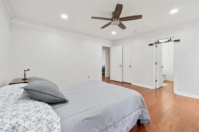 a bedroom with a large bed and a ceiling fan