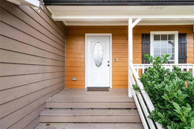 a view of front door of house with stairs