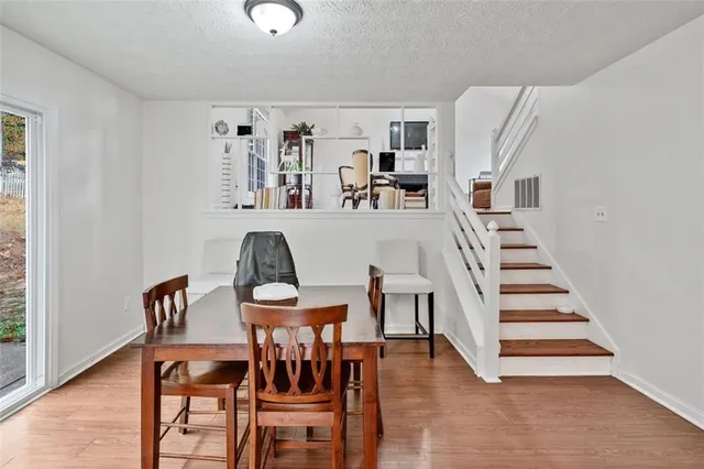a view of a dining room with furniture and wooden floor