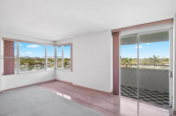 a view of an empty room and a window