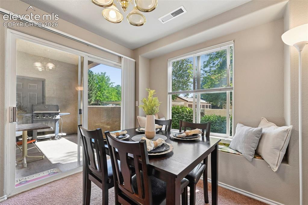 3715 Riviera Grove, Unit 101 Colorado Springs, CO 80922 - Photo 15 of 36 Dining area with sliding glass door access to an outdoor patio