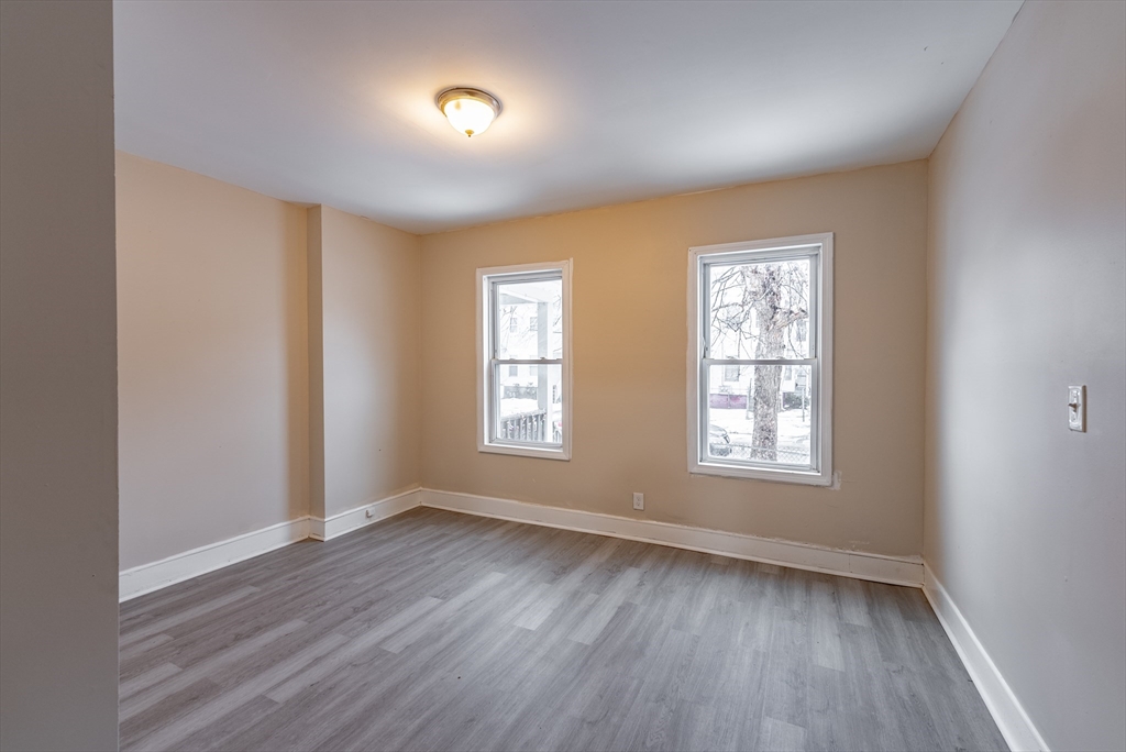 84-86 Bowles Street Springfield, MA 01109 - Photo 12 of 21 an empty room with wooden floor and windows