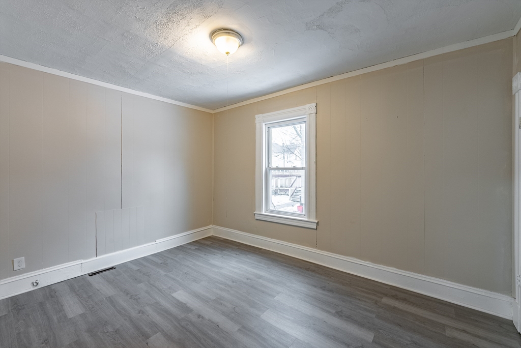 84-86 Bowles Street Springfield, MA 01109 - Photo 15 of 21 an empty room with wooden floor and windows