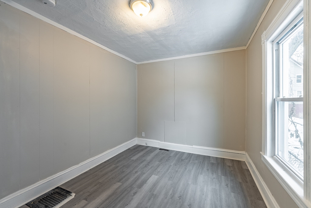 84-86 Bowles Street Springfield, MA 01109 - Photo 16 of 21 an empty room with wooden floor and windows