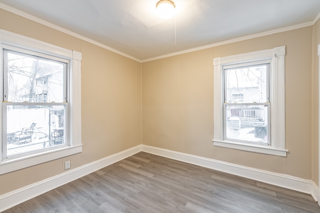 84-86 Bowles Street Springfield, MA 01109 - Photo 19 of 21 a view of an empty room with wooden floor and a window