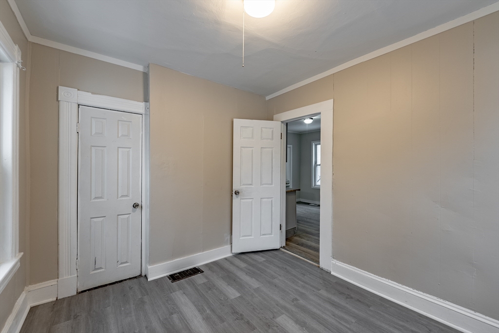 84-86 Bowles Street Springfield, MA 01109 - Photo 20 of 21 an empty room with wooden floor and closet