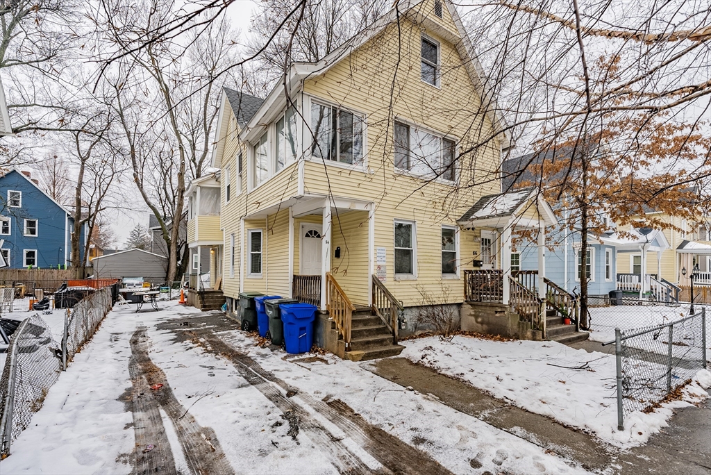 84-86 Bowles Street Springfield, MA 01109 - Photo 2 of 21 a view of a white house with a wooden fence