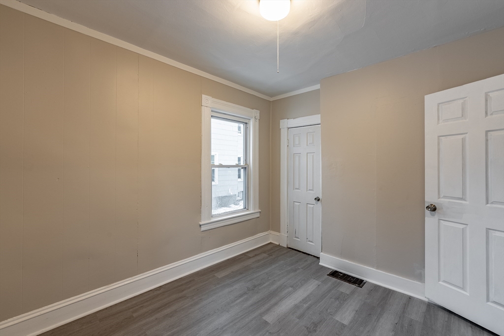84-86 Bowles Street Springfield, MA 01109 - Photo 21 of 21 an empty room with wooden floor and windows