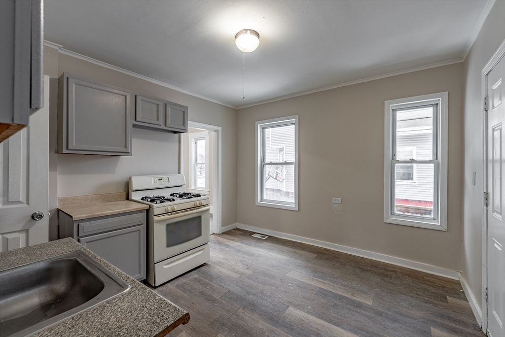 84-86 Bowles Street Springfield, MA 01109 - Photo 3 of 21 a kitchen with stainless steel appliances granite countertop a stove a sink and a refrigerator