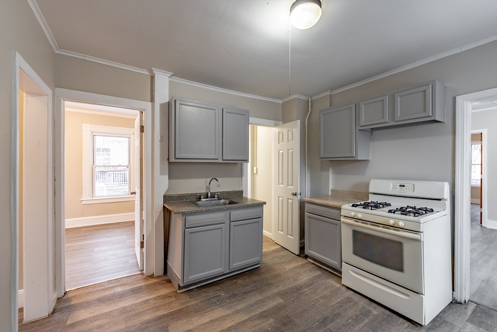 84-86 Bowles Street Springfield, MA 01109 - Photo 4 of 21 a kitchen with a stove a sink and a refrigerator