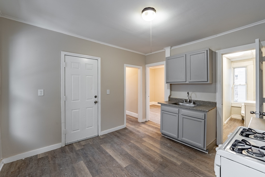 84-86 Bowles Street Springfield, MA 01109 - Photo 6 of 21 a kitchen with a stove a sink and a refrigerator
