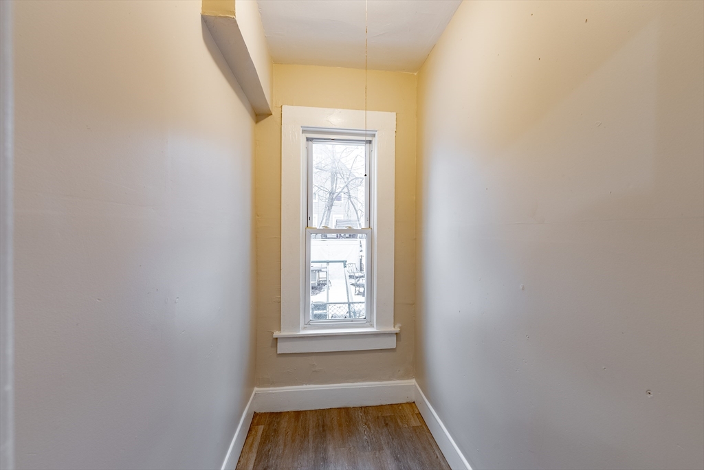 84-86 Bowles Street Springfield, MA 01109 - Photo 7 of 21 a view of a room with wooden floor and window