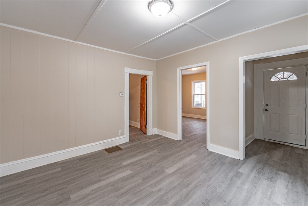 84-86 Bowles Street Springfield, MA 01109 - Photo 8 of 21 an empty room with wooden floor and windows