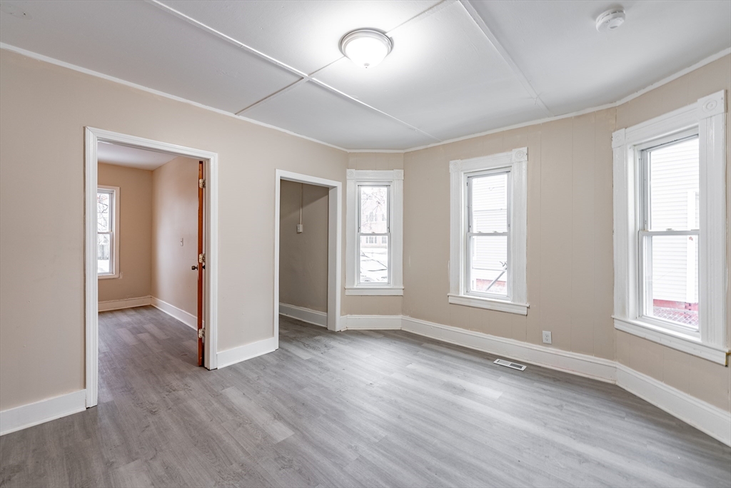 84-86 Bowles Street Springfield, MA 01109 - Photo 9 of 21 an empty room with wooden floor and windows