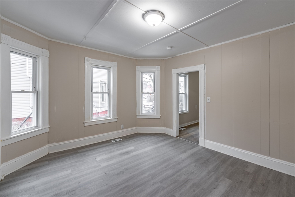 84-86 Bowles Street Springfield, MA 01109 - Photo 10 of 21 an empty room with wooden floor and windows