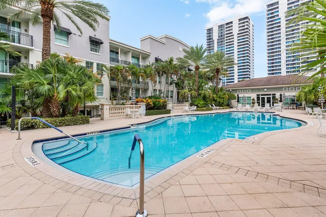 a swimming pool with outdoor seating and yard