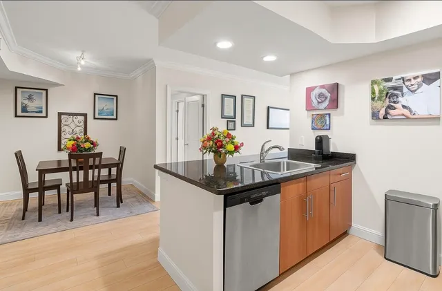 a view of a kitchen area with furniture and wooden floor