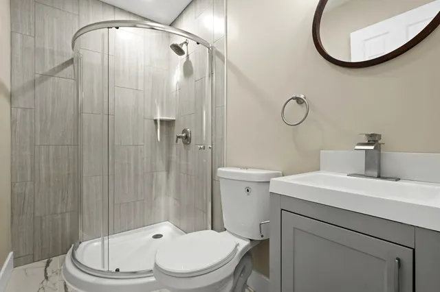 a white toilet sitting next to a bathroom sink