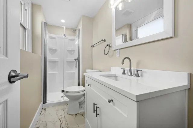a bathroom with a sink toilet and shower