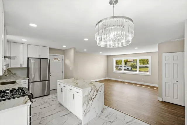 a kitchen with stainless steel appliances a refrigerator and a stove top oven