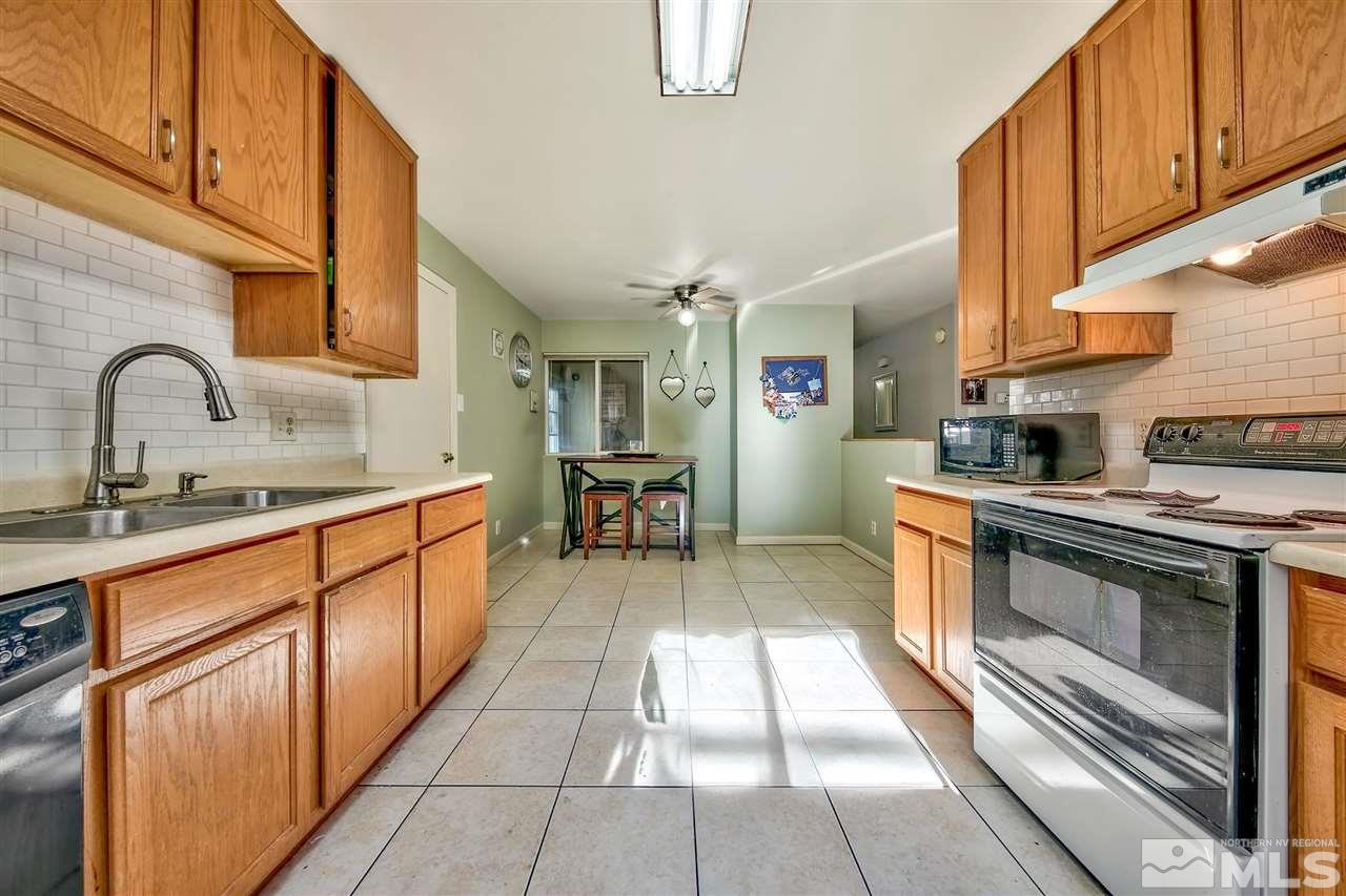 1201 Colusa Drive Reno, NV 89503 - Photo 6 of 15 a kitchen with stainless steel appliances granite countertop a stove a sink and a microwave
