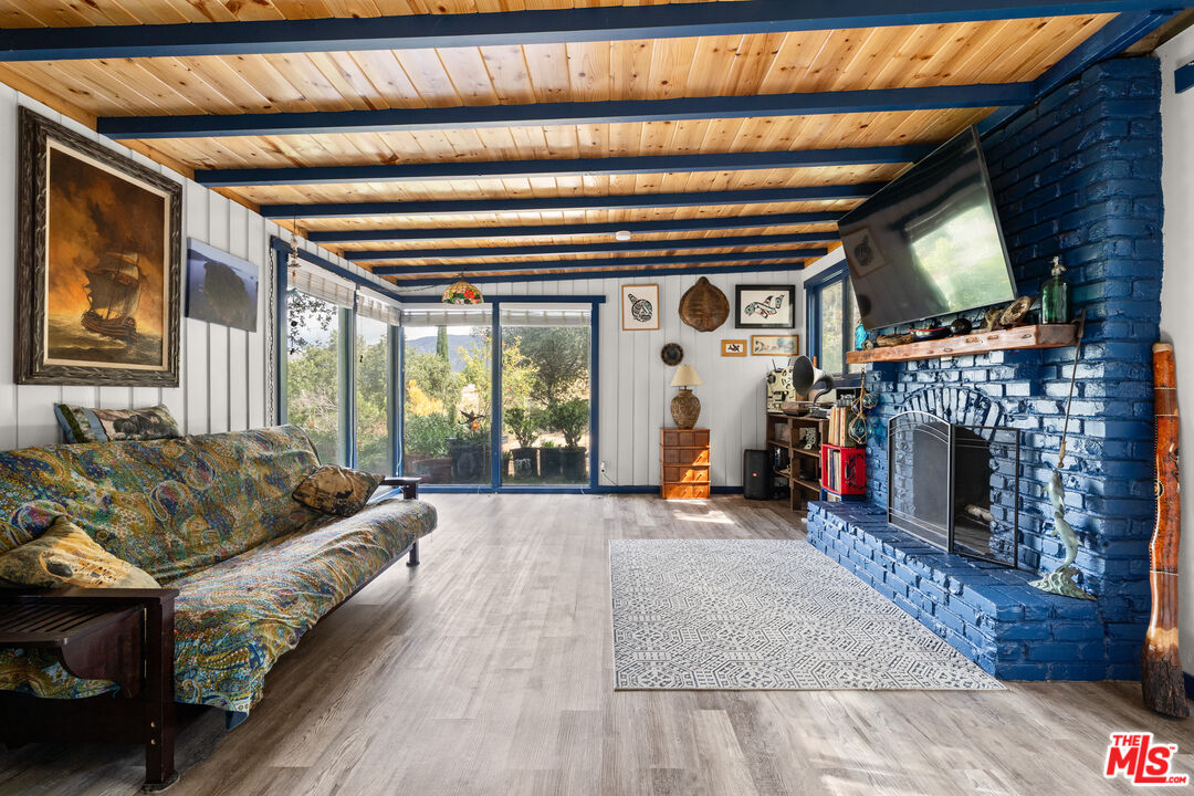 9738 Commerce Avenue Tujunga, CA 91042 - Photo 2 of 17 a living room with furniture and a fireplace