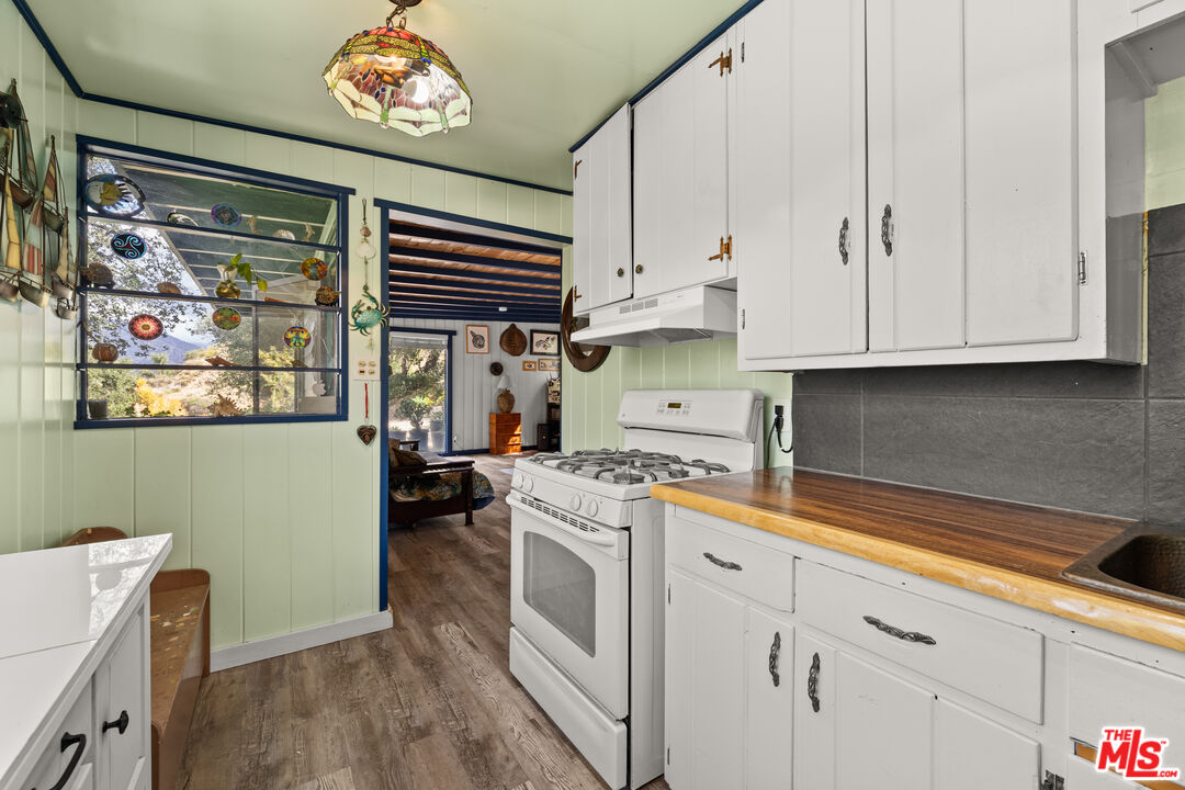 9738 Commerce Avenue Tujunga, CA 91042 - Photo 5 of 17 a kitchen with a stove and a microwave