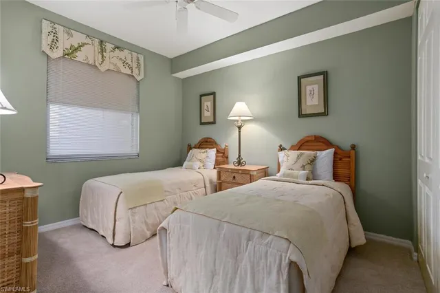 a bedroom with two beds and a night stand