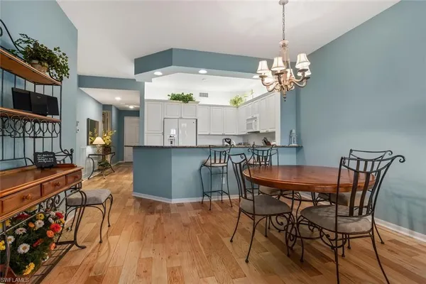 a view of a dining room with furniture wooden floor and chandelier