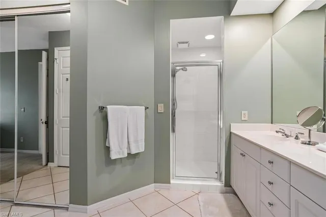 a bathroom with a double vanity sink mirror and shower