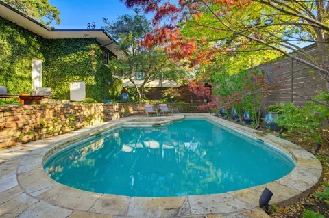 a view of a swimming pool with a yard