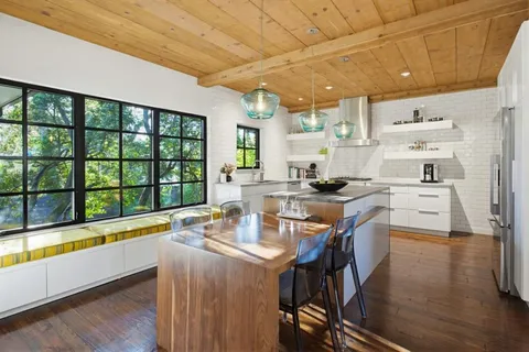 a kitchen with stainless steel appliances granite countertop sink stove and wooden cabinets