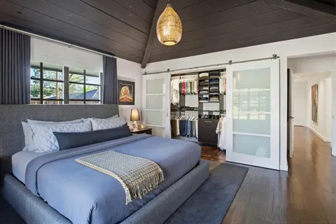 a bedroom with a large bed and a window