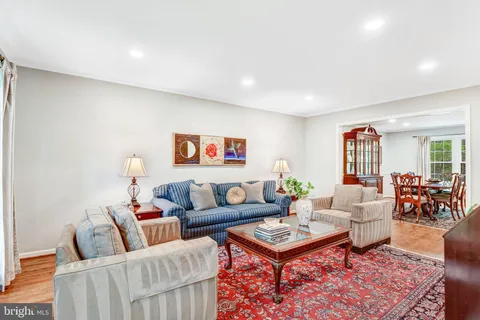 a living room with furniture a rug and a window