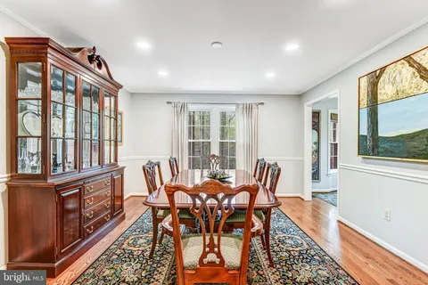 a dining room with furniture a rug and wooden floor