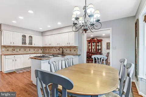 a large kitchen with a table and chairs