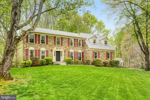 a view of a brick house with a yard