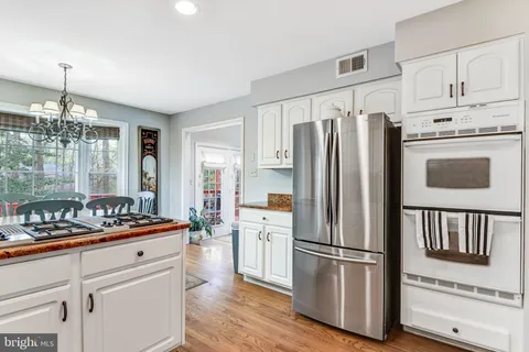 a kitchen with stainless steel appliances a refrigerator sink and cabinets