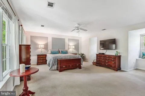 a bedroom with furniture and a flat screen tv