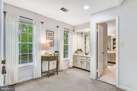a view of a bedroom with furniture and windows