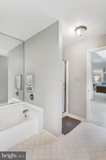 a bathroom with a tub shower and sink