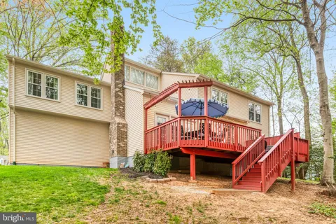 a view of a swimming pool with lawn chairs under an umbrella
