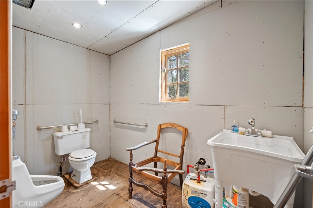 1918 East Main Street Quincy, CA 95971 - Photo 24 of 28 a bathroom with a sink mirror vanity and toilet