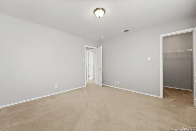 a view of a pathway with a wrought fence