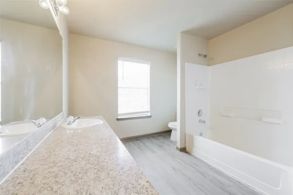 a spacious bathroom with a bathtub and window