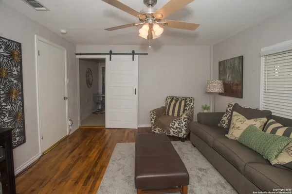 a view of a livingroom with a fireplace a microwave and a potted plant