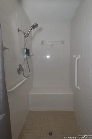 a utility room with lots of clutter and cabinets