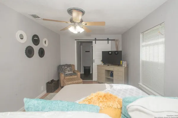 a bedroom with a bed and a chandelier