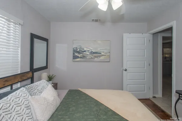 a bedroom with a bed and a flat tv screen